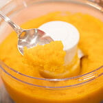 Close-up of thick and smooth homemade pumpkin puree in a food processor