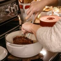 A women pulling apart a fajita beef roast