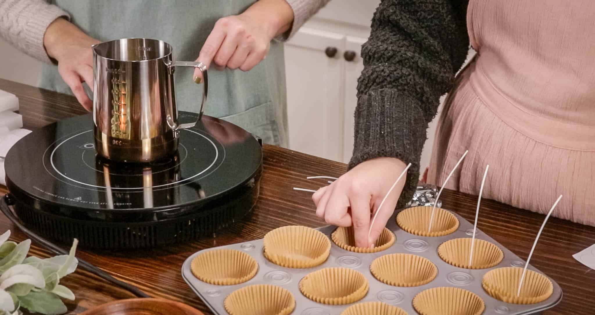 a women in a cottage kitchen placing muffin liners into a muffin tin