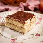 A upclose of a slice of eggless tiramisu recipe is perfect for coffee lovers looking for a sweet and creamy treat.