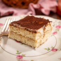 A upclose of a slice of eggless tiramisu recipe is perfect for coffee lovers looking for a sweet and creamy treat.