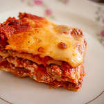 a slice of lasagna on a plate of china