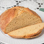 Close view of a freshly baked sourdough Irish soda bread loaf sliced open to show the soft crumb and golden crust.