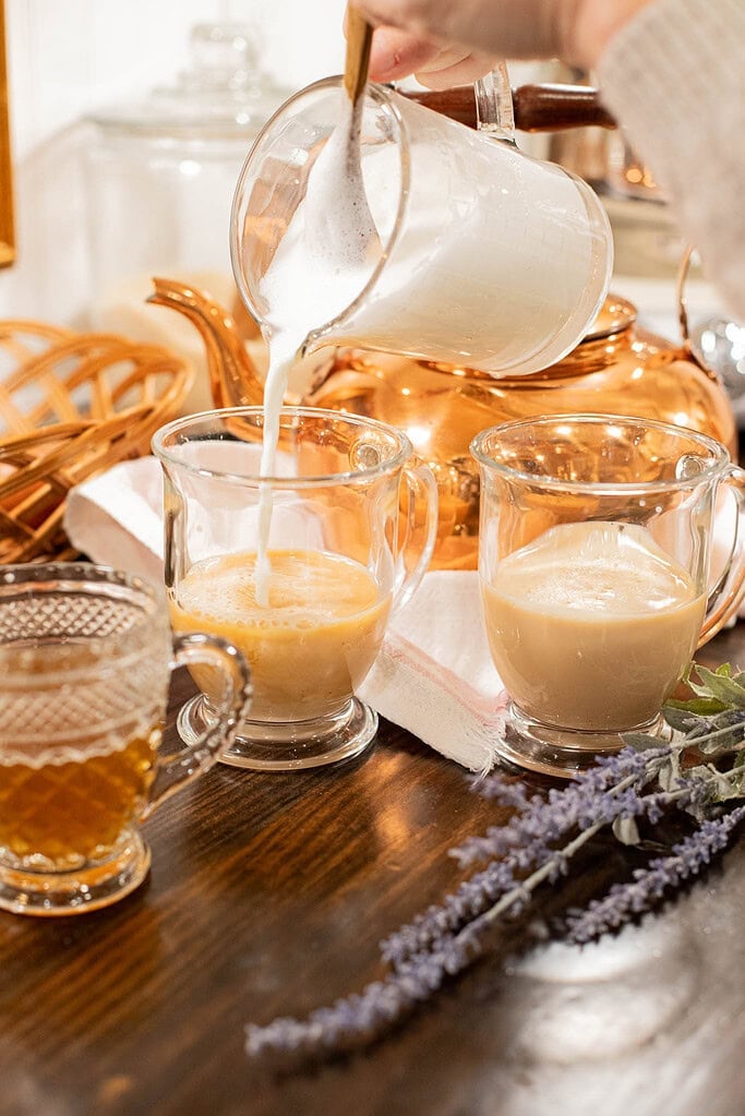 pouring steamed milk into Earl Grey tea to make a London fog latte