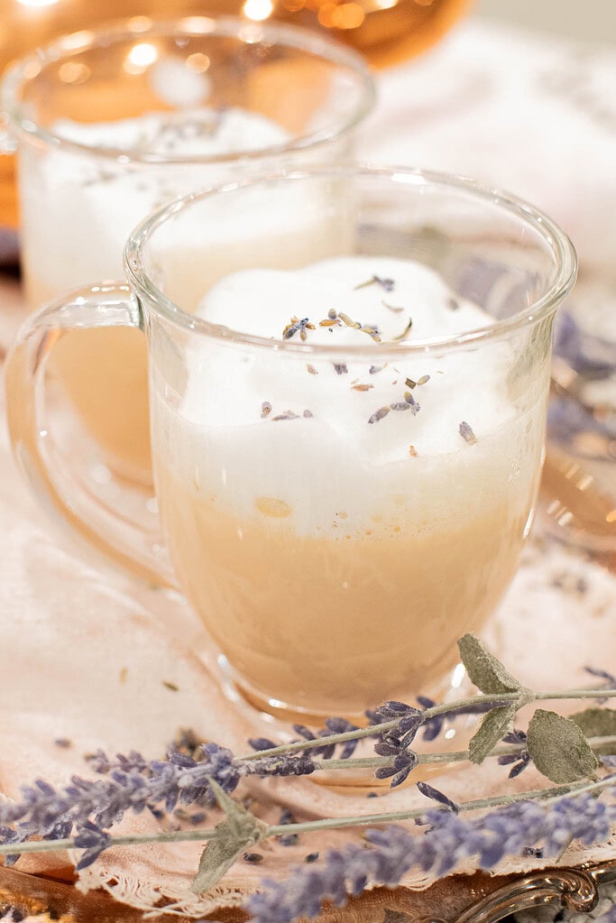 close up of London fog latte with frothy milk and lavender garnish