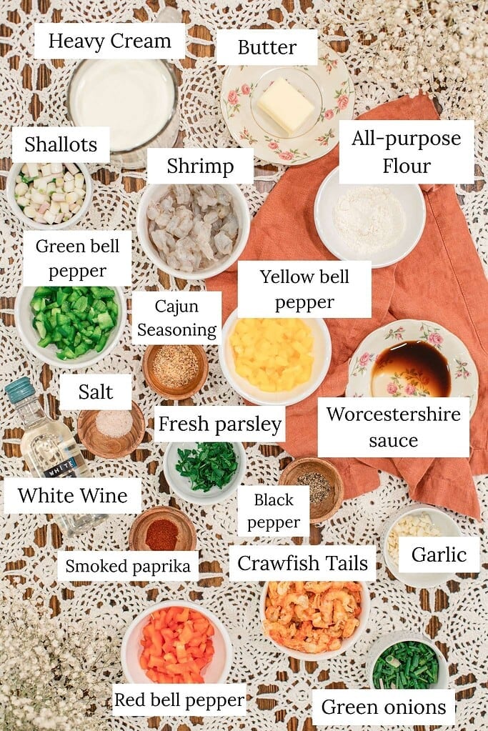 Ingredients for a shrimp and crawfish étouffée recipe including shrimp, crawfish tails, peppers, cream, butter, and Cajun seasoning