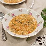 A slightly different angle of two bowls of étouffée, highlighting the creamy texture and colorful ingredients.