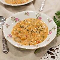 A slightly different angle of two bowls of étouffée, highlighting the creamy texture and colorful ingredients.