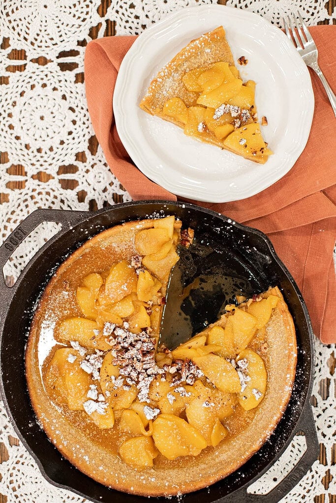 sourdough dutch baby pancake with caramel apples baked in cast iron skillet
