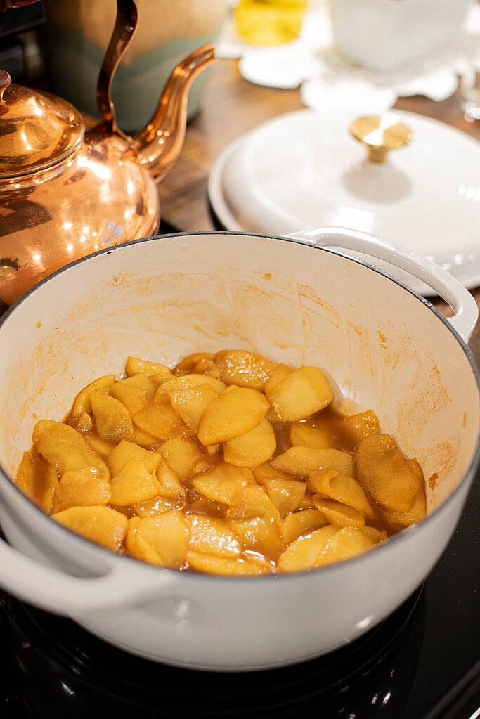 homemade caramelized apples cooking on stovetop for dutch baby topping