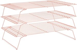 A three-tier rose gold cooling rack, made of metal wire, designed for stacking baked goods while cooling. The racks are foldable and angled slightly for compact storage.