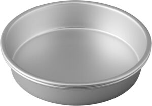 A silver aluminum round cake pan with straight sides, commonly used for baking layered cakes.