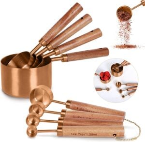 Copper Measuring Cups and Spoons Set Rustic copper and wood measuring cup and spoon set, a charming and functional kitchen tool for precise baking and preserving.
