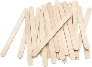 A scattered bundle of natural wooden popsicle sticks—simple, nostalgic tools ready for a sweet summer treat.