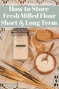 Glass jar of freshly milled hard red wheat flour with whole wheat berries and wooden scoops, with text overlay reading “How to Store Fresh Milled Flour Short & Long Term.”