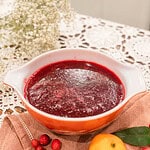 A bowl of freshly blended cranberry orange sauce cooling on the counter, showing its smooth, glossy texture.
