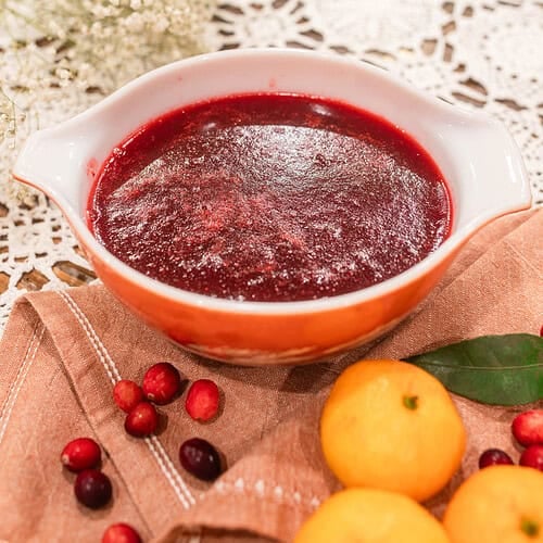 A bowl of freshly blended cranberry orange sauce cooling on the counter, showing its smooth, glossy texture.
