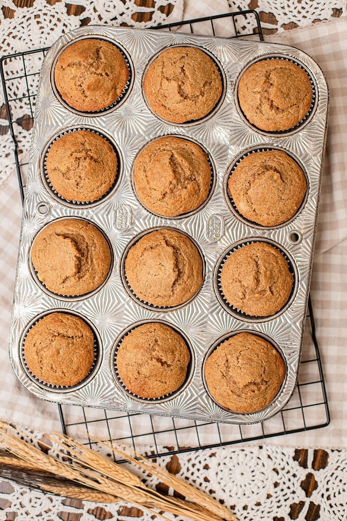 Freshly baked banana muffins with freshly milled flour cooling in a vintage muffin tin