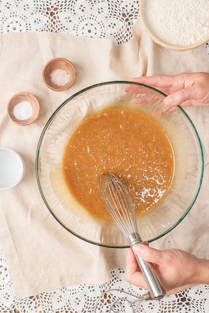 Whisked brown butter sourdough cookie batter showing a smooth, bubbly texture before the dry ingredients are added