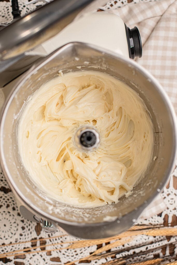 Cream cheese frosting whipped smooth in a stand mixer for cinnamon rolls made with freshly milled flour