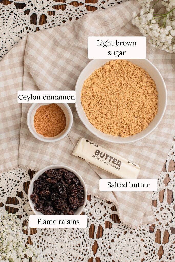 Ingredients for cinnamon rolls made with freshly milled flour, including light brown sugar, Ceylon cinnamon, salted butter, and flame raisins