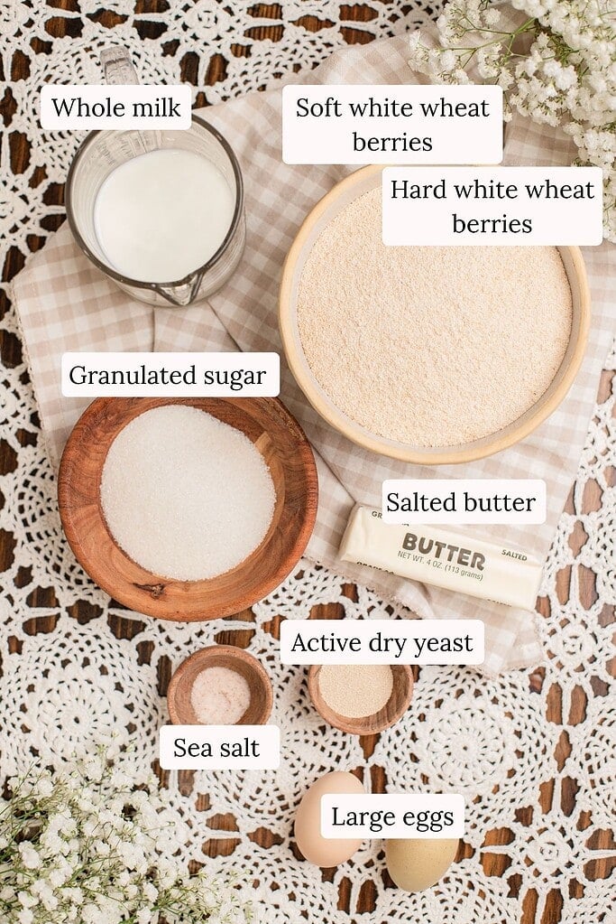 Labeled dough ingredients for freshly milled flour cinnamon rolls, including soft and hard white wheat berries, whole milk, and active dry yeast