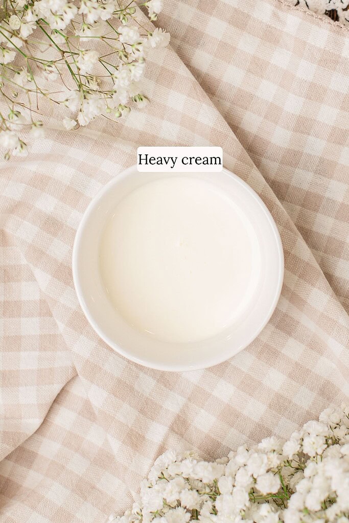 Heavy cream measured for soaking cinnamon rolls made with freshly milled flour before baking