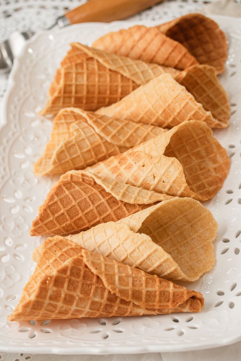 A platter of homemade waffle cones made with fresh milled flour arranged together, showing their crisp golden color and classic waffle cone texture.