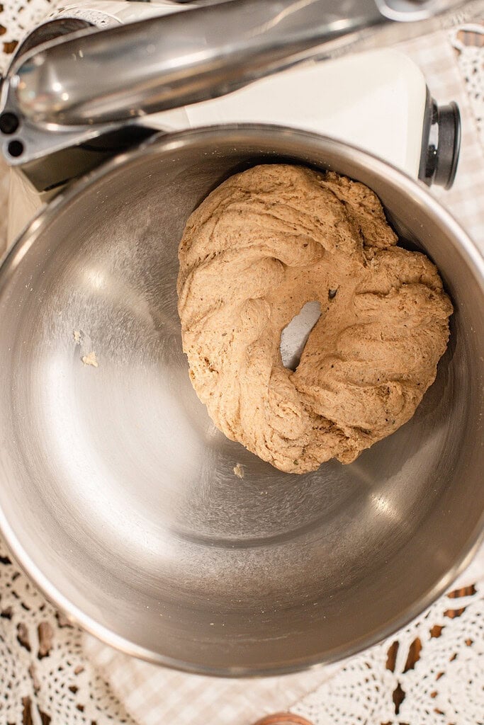 Mixed freshly milled flour pizza dough resting in a stainless steel mixing bowl, still shaggy and unkneaded