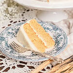 Yellow Cake Made with Freshly Milled Flour sliced open on a cake stand showing tender golden layers