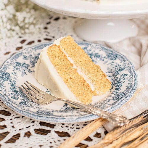 Yellow Cake Made with Freshly Milled Flour sliced open on a cake stand showing tender golden layers