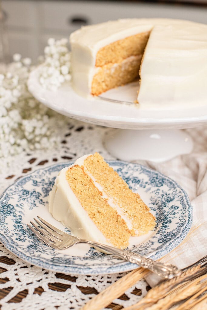 Yellow Cake Made with Freshly Milled Flour sliced open on a cake stand showing tender golden layers
